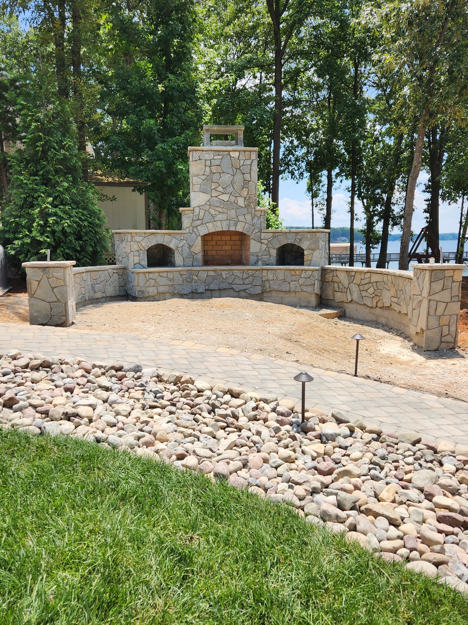 Custom outdoor stone fireplace on Lake Norman lakeside property by SD Masonry