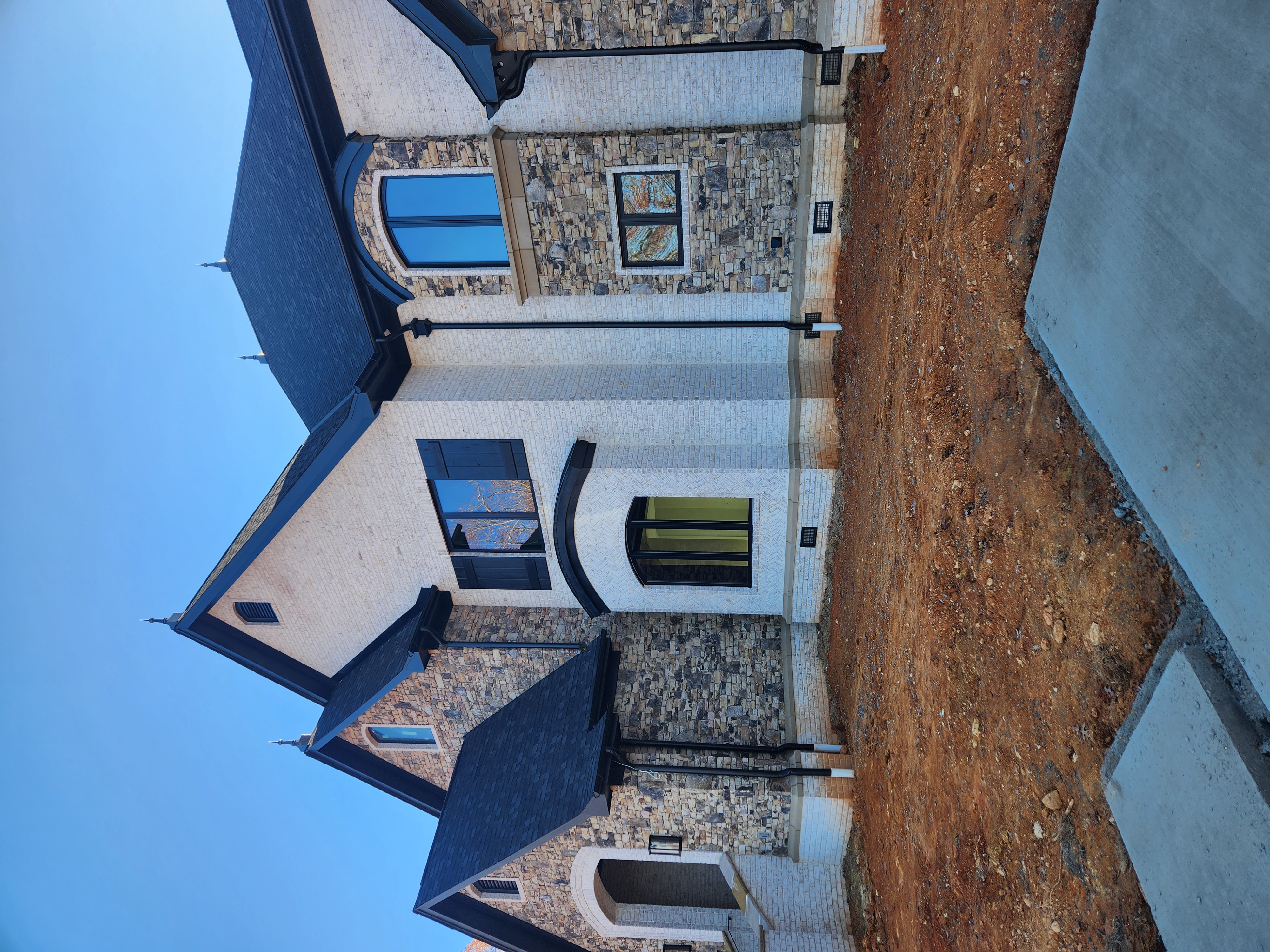 Custom stone and brick home under construction by SD Masonry