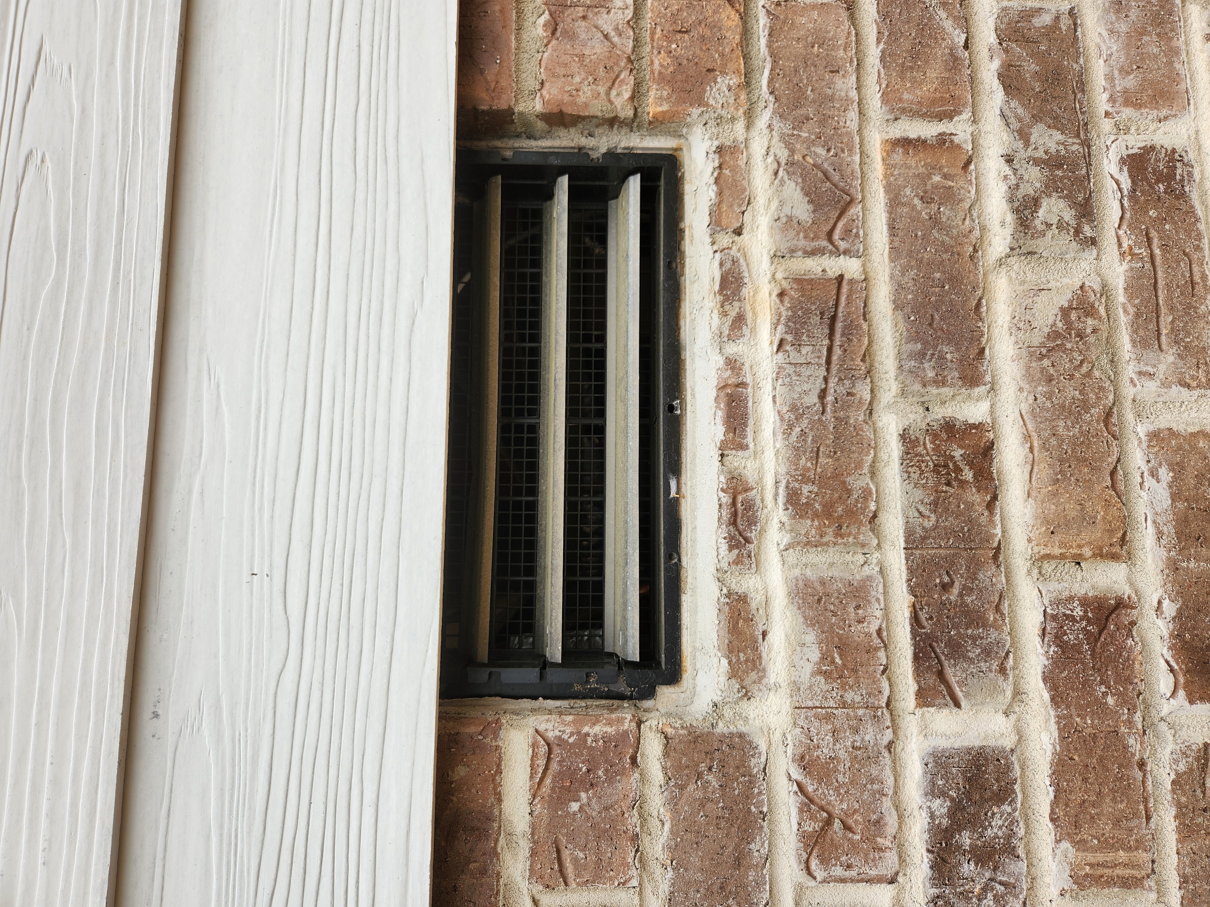 Brick repair and restoration around a vent by SD Masonry in Charlotte, NC